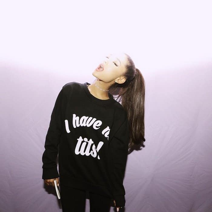 Ariana Grande shared a photo wearing an O’Mighty 'I have no tits!' sweater ($60.50) with a series of hashtags to promote body positivity and self-love among girls
