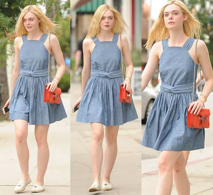 Elle Fanning effortlessly embraces the essence of a delightful day out in a charming chambray dress adorned with knotted details at the midriff