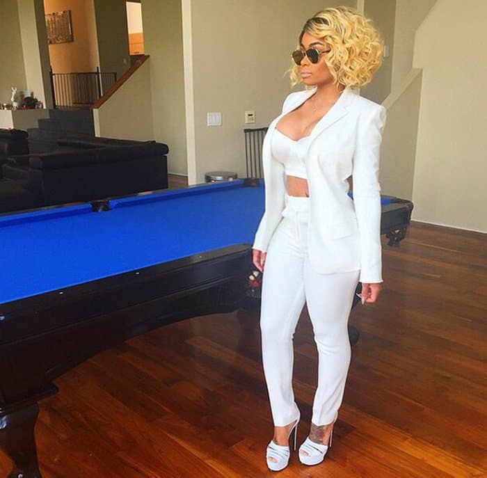Blac Chyna in a white pantsuit ensemble with a sexy twist