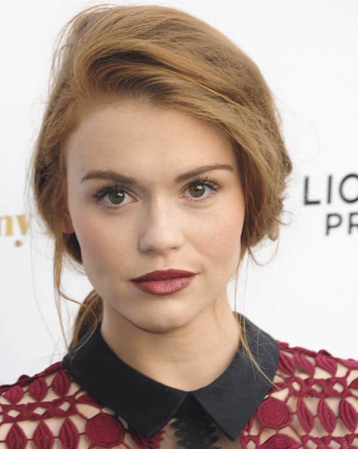 Actress Holland Roden swept her auburn locks back into a messy ponytail and added a matching berry lip to complement her raspberry-colored crochet dress from Self-Portrait