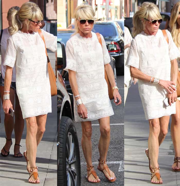 Kristin Chenoweth's errand ensemble featured a white eyelet shift dress paired with brown sandals, a shoulder bag, bracelets, a gold-tone watch, and sunglasses