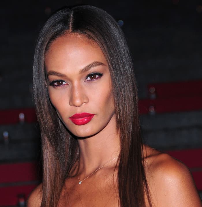Model Joan Smalls, with her sleek, straight locks cascading down and a bold red lip adding a pop of color, at the Vanity Fair Party during the 2015 Tribeca Film Festival