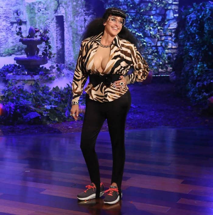 Ellen DeGeneres dressed up as Karla Kardashian for Halloween with a long blond wig, a tight leopard print dress, and a lot of jewelry