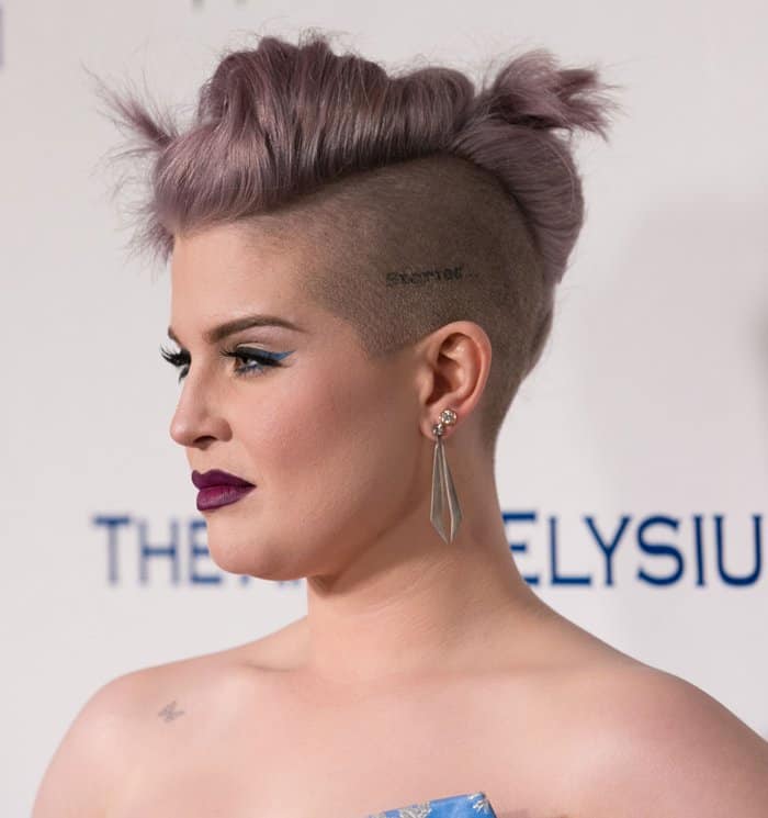 Kelly Osbourne completed the look with a perfectly coiffed up-do and gothic-inspired makeup with bold eyeliner and a deep purple lipstick