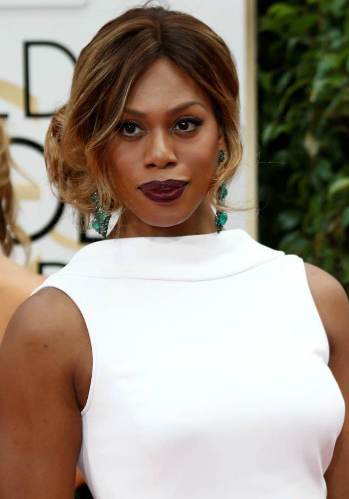 Laverne Cox wearing a custom-made white Elizabeth Kennedy gown on the red carpet of the Golden Globes held at the Beverly Hilton Hotel on January 10, 2016 in Beverly Hills, California