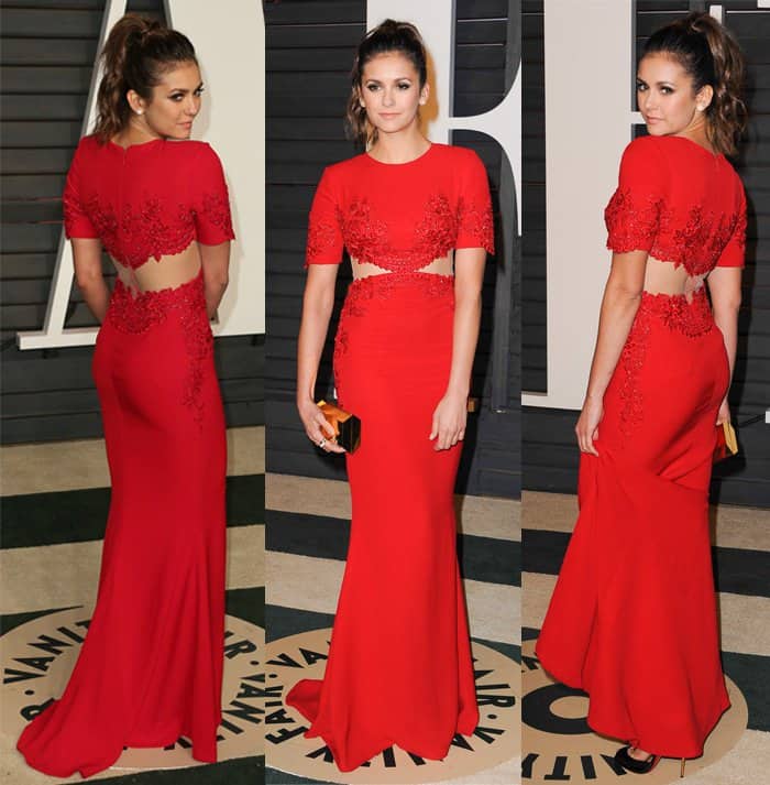 Nina Dobrev in a beautiful red Reem Acra gown and black Louboutin heels adorned with gold studs at the 2015 Vanity Fair Oscar Party