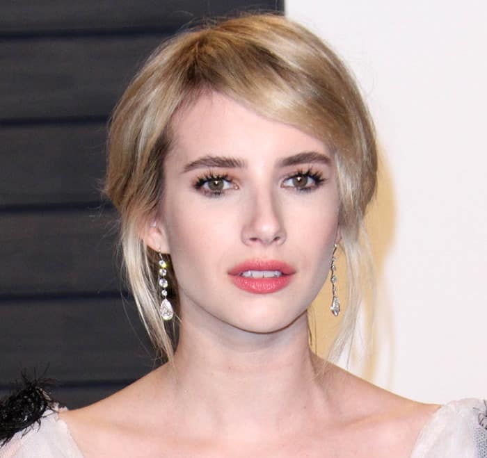 Emma Roberts complemented the look with a sophisticated up-do featuring side swept bangs and bold red lips