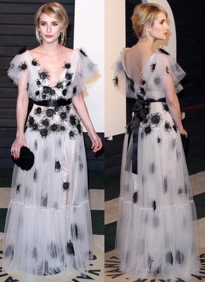 Emma Roberts donned a stunning gown made of white tulle and black dotted feathers, featuring a tasteful v-neckline and a chic black satin tie waist