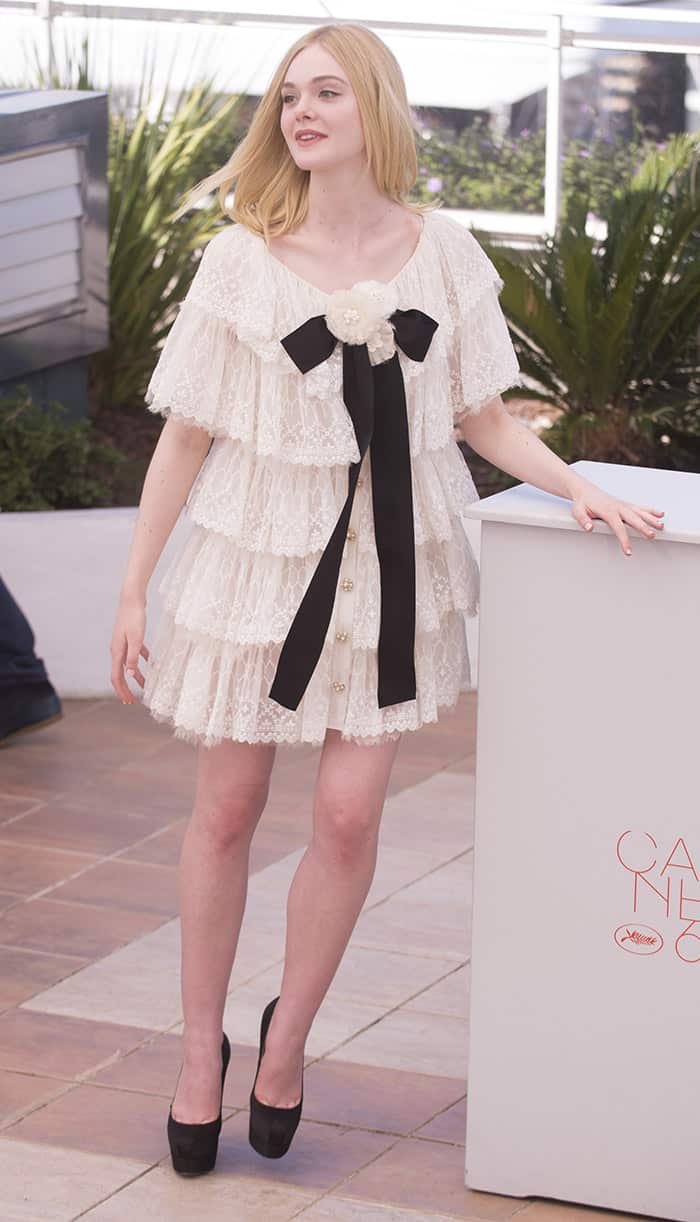 Elle Fanning's dress was elegantly enhanced with a contrasting black satin necktie and closed with pearl buttons