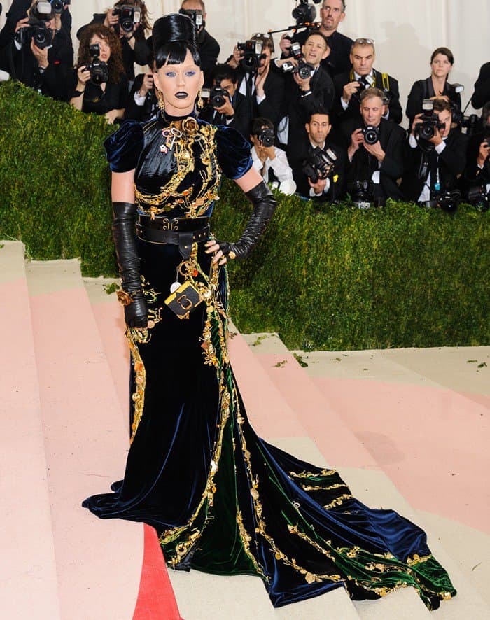 Katy Perry's floor-length velvet dress, characterized by a modest neckline and voluminous sleeves, incorporated a 3-D touch with keys and a padlock adorning the pop star's waist and neck
