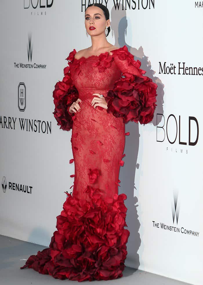Katy Perry radiated beauty in a Marchesa red off-the-shoulder gown adorned with intricate lace and petal embroidery
