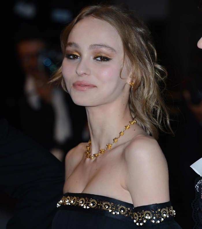 Lily-Rose Depp's accessories remained understated with a refined gold necklace and matching earrings