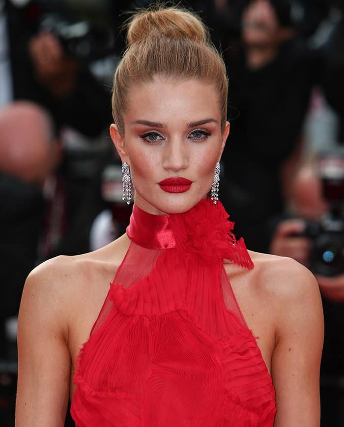 The ensemble was impeccably pulled together with Rosie Huntington-Whiteley's choice of bold red lipstick and sparkling jewelry