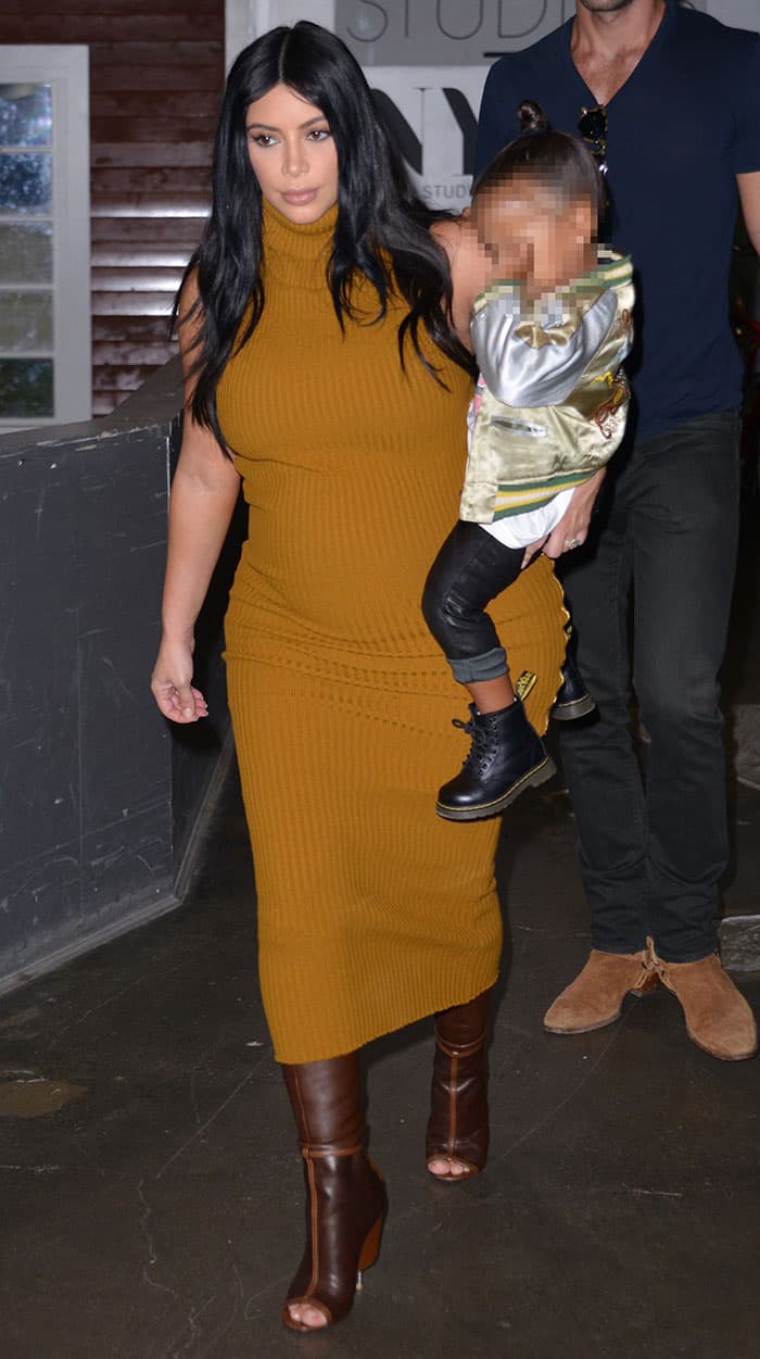 Kim Kardashian flaunting her baby bump in a Laquan Smith Fall 2015 mustard rib dress