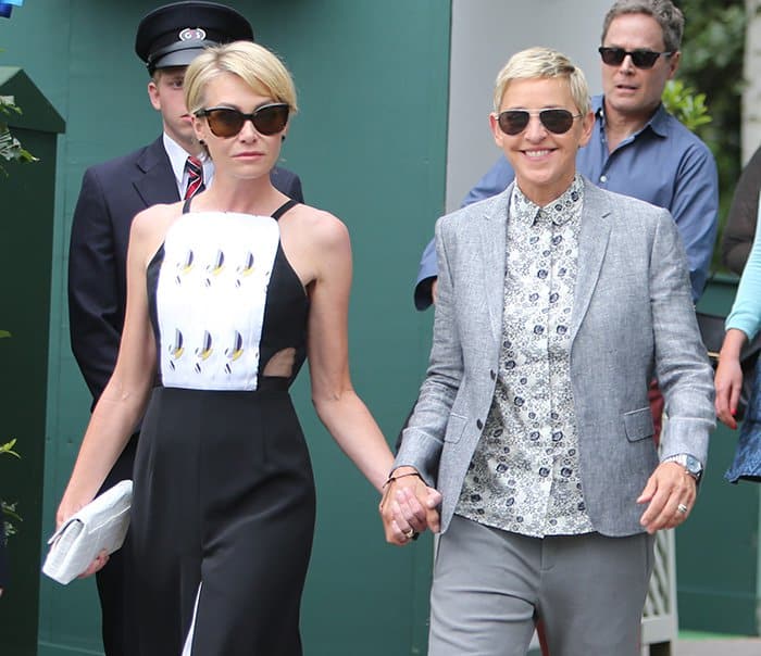 Portia de Rossi and Ellen Degeneres walking hand-in-hand while arriving at the final day of the Wimbledon Championships in London