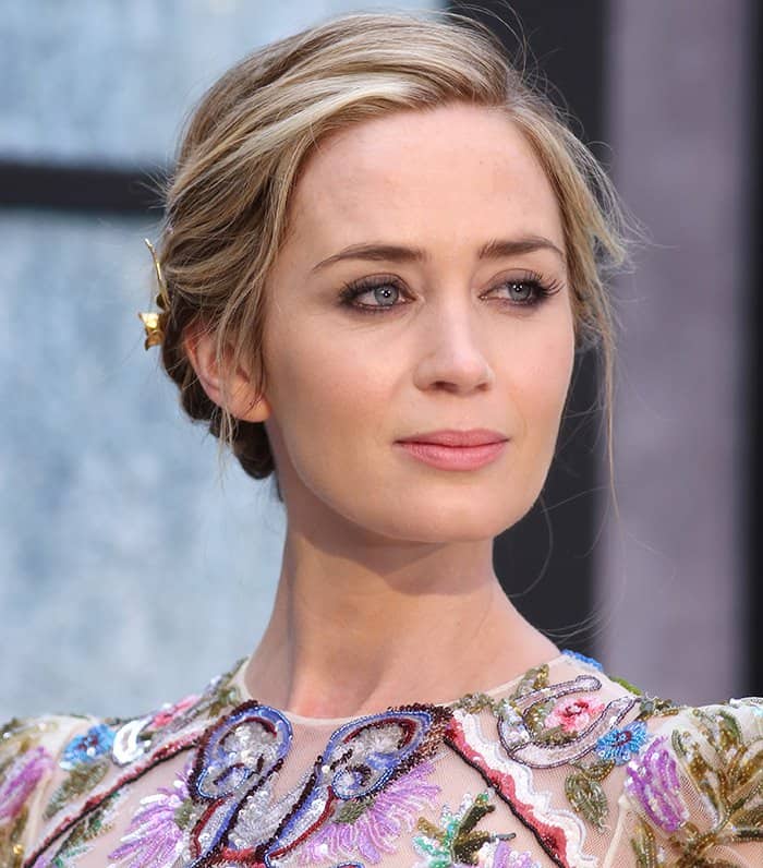 Emily Blunt's kohl-rimmed smoky eye artfully highlighted the dress's darker beading, adding a touch of autumnal allure