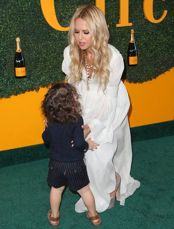 Rachel Zoe's two-year-old son Kaius was impeccably dressed in a navy blue jacket, shorts, and brown sandals