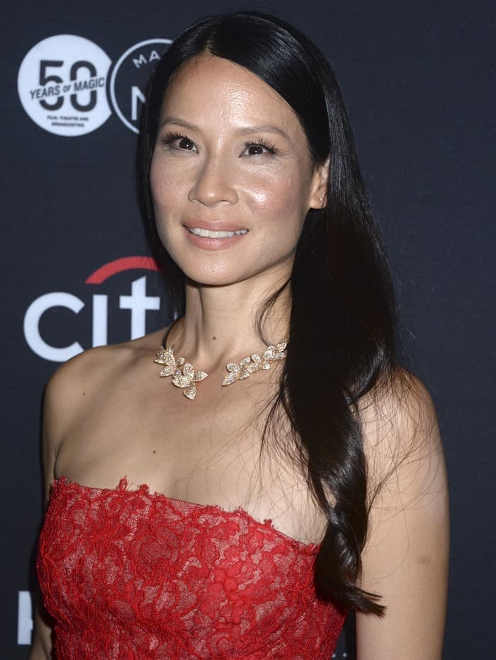Lucy Liu dressed up her red strapless layered lace cocktail dress with a gold leaf choker
