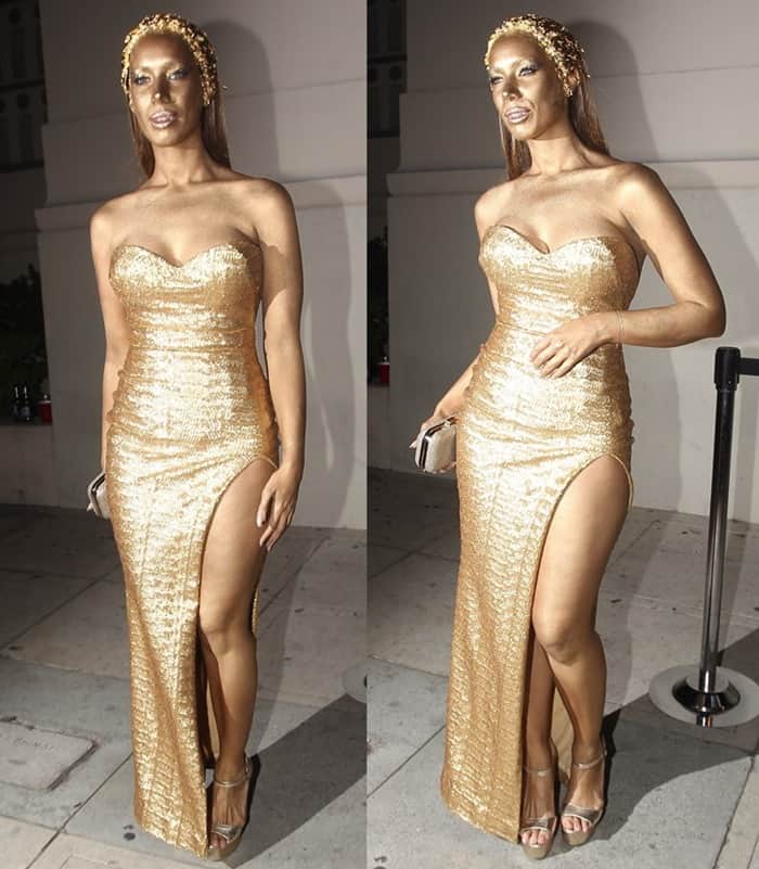 Leona Lewis as a metallic statue in a strapless gold evening gown
