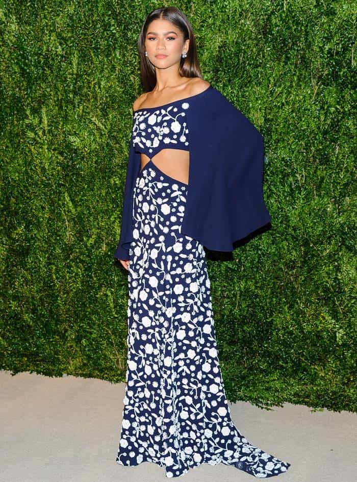 The fashion-forward singer and actress Zendaya was draped in a navy, off-the-shoulder dress from the Michael Kors Collection, adorned with white floral embellishments