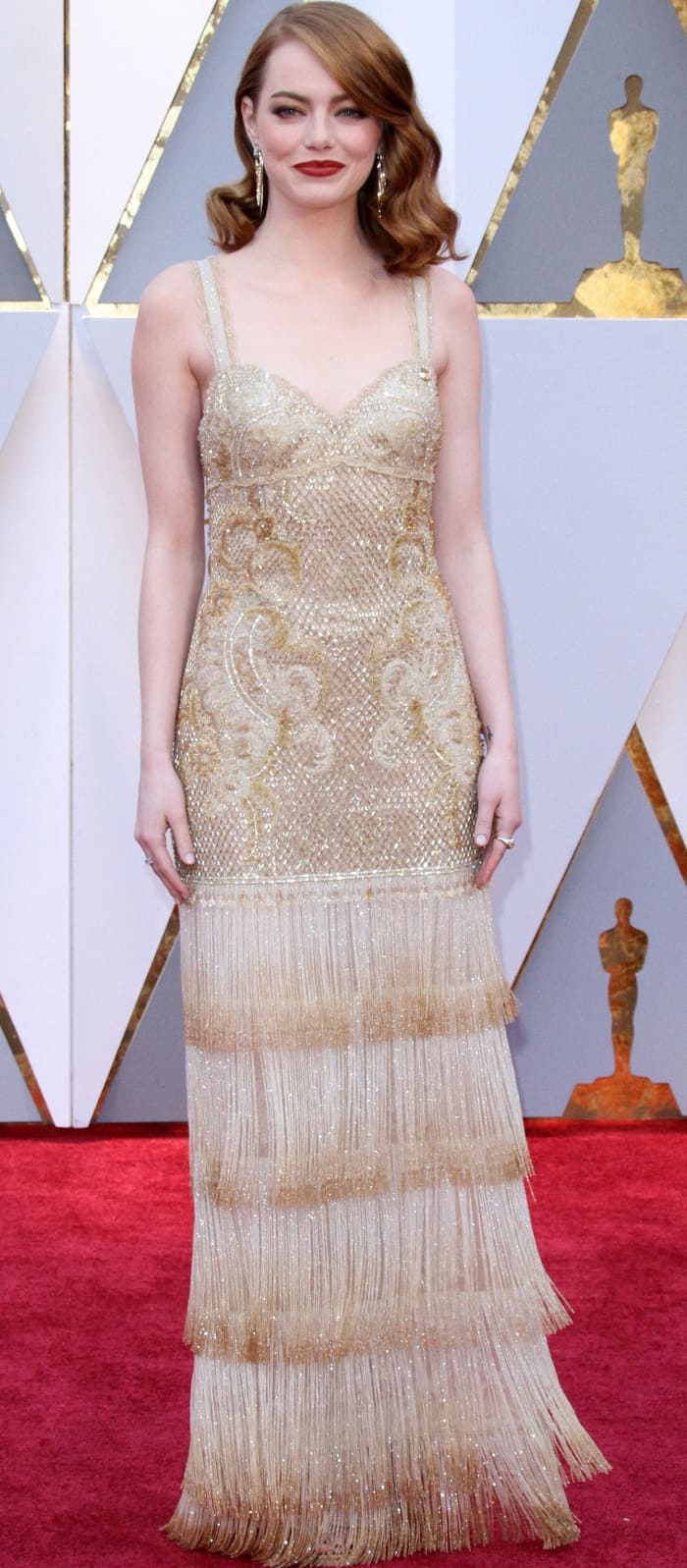 Emma Stone wearing a gold embellished gown from Givenchy at the 2017 Oscars