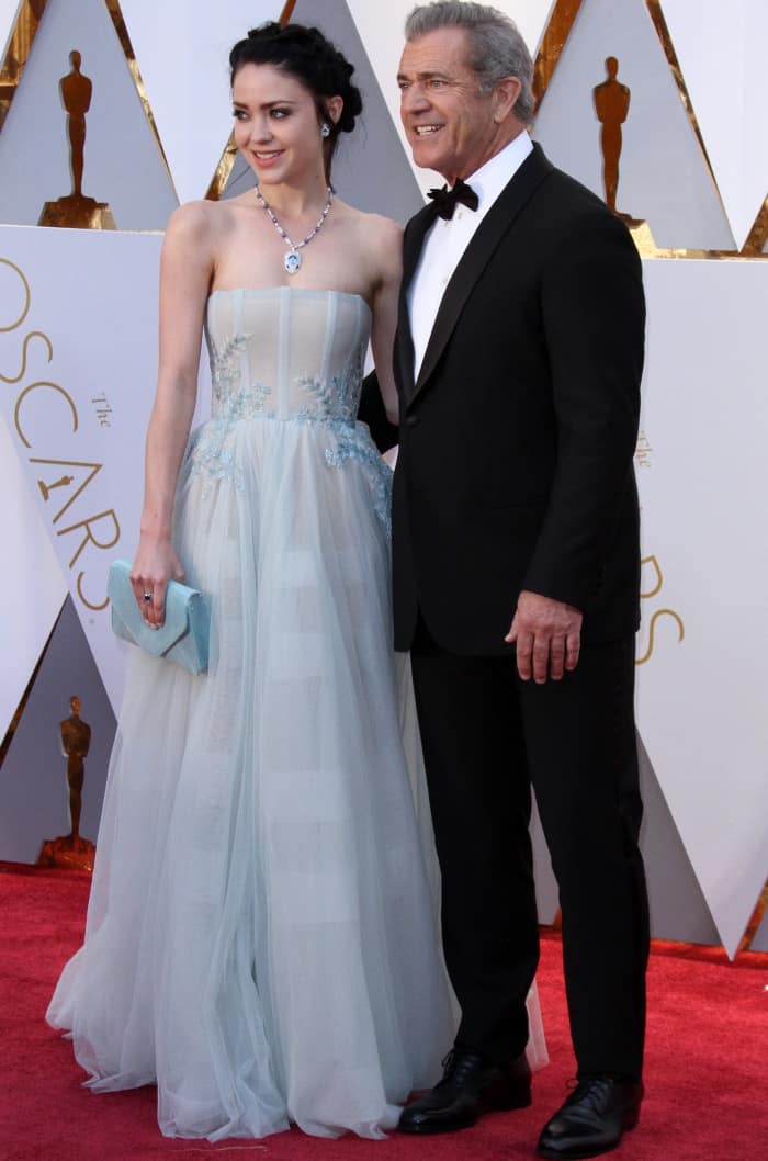 Rosalind Ross wearing a powder blue gown and Mel Gibson wearing a Giorgio Armani suit at the 2017 Oscars