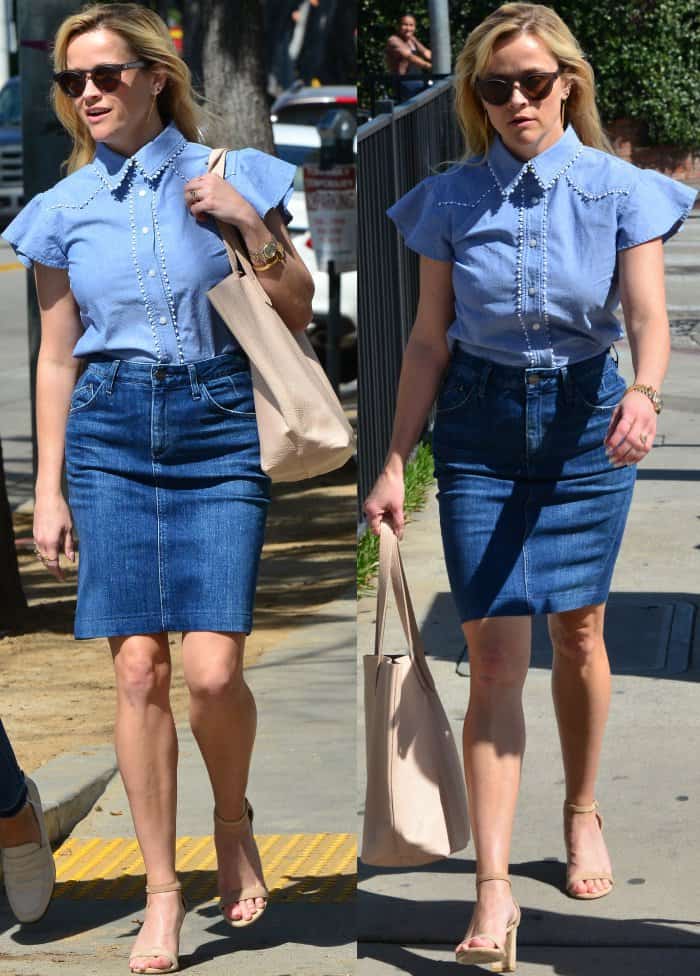 Reese Witherspoon wearing the Ruffle Chambray Button Down from Draper James, a denim skirt, and nude ankle-strap sandals