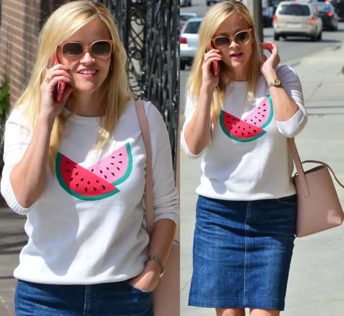 Reese Witherspoon wearing the Watermelon Sweater from Draper James, a denim skirt, and pink pointy-toe pumps