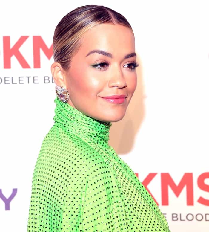 Rita Ora styled the green frock with multicolored crystal earrings