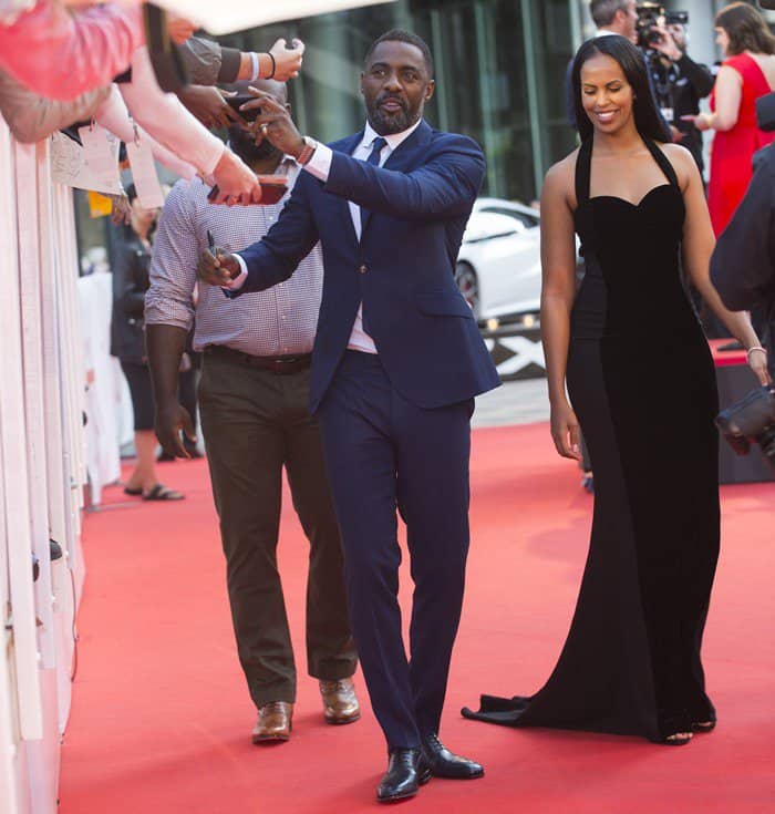 45-year-old English actor Idris Elba arriving with his 29-year-old girlfriend Sabrina Dhowre